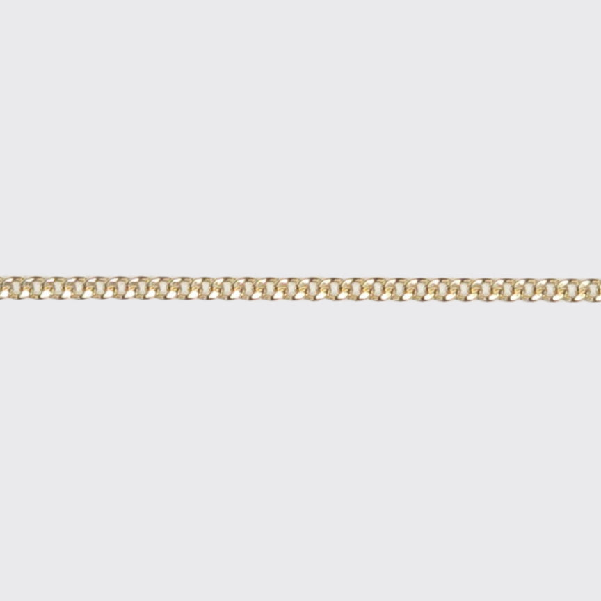 Close-up of a small Cuban chain in 14k gold filled metal, featuring sleek, tightly interlocked 2mm flat links—designed for permanent jewelry with everyday durability.