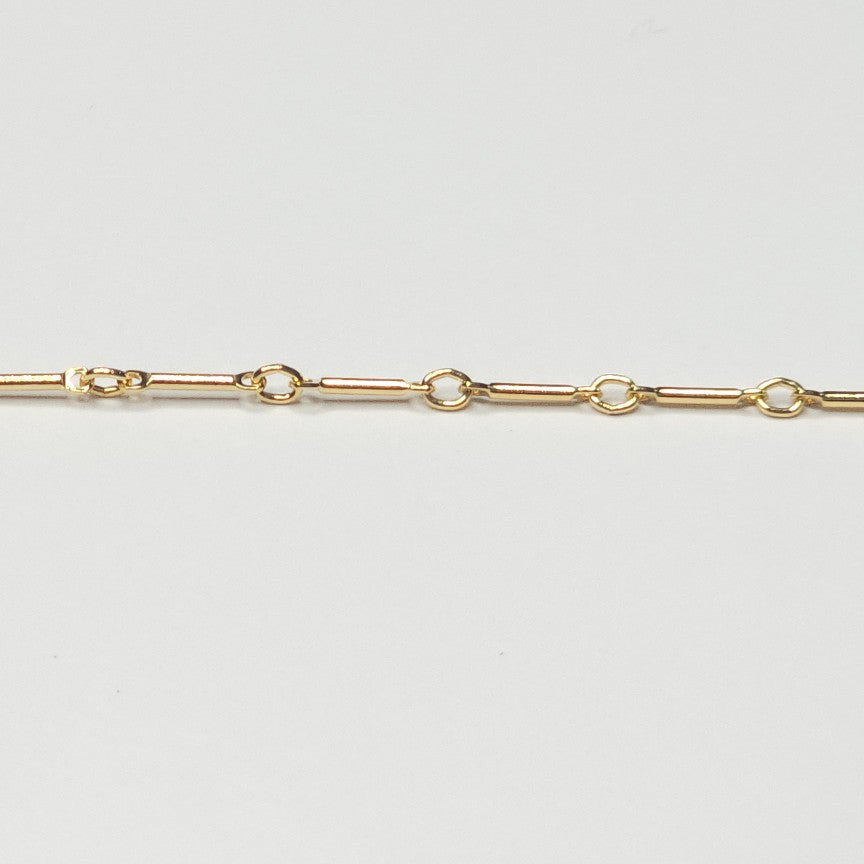 Polished and lightweight 14k gold filled bar chain with alternating vertical bars and small loops, crafted for intentional, everyday wear.