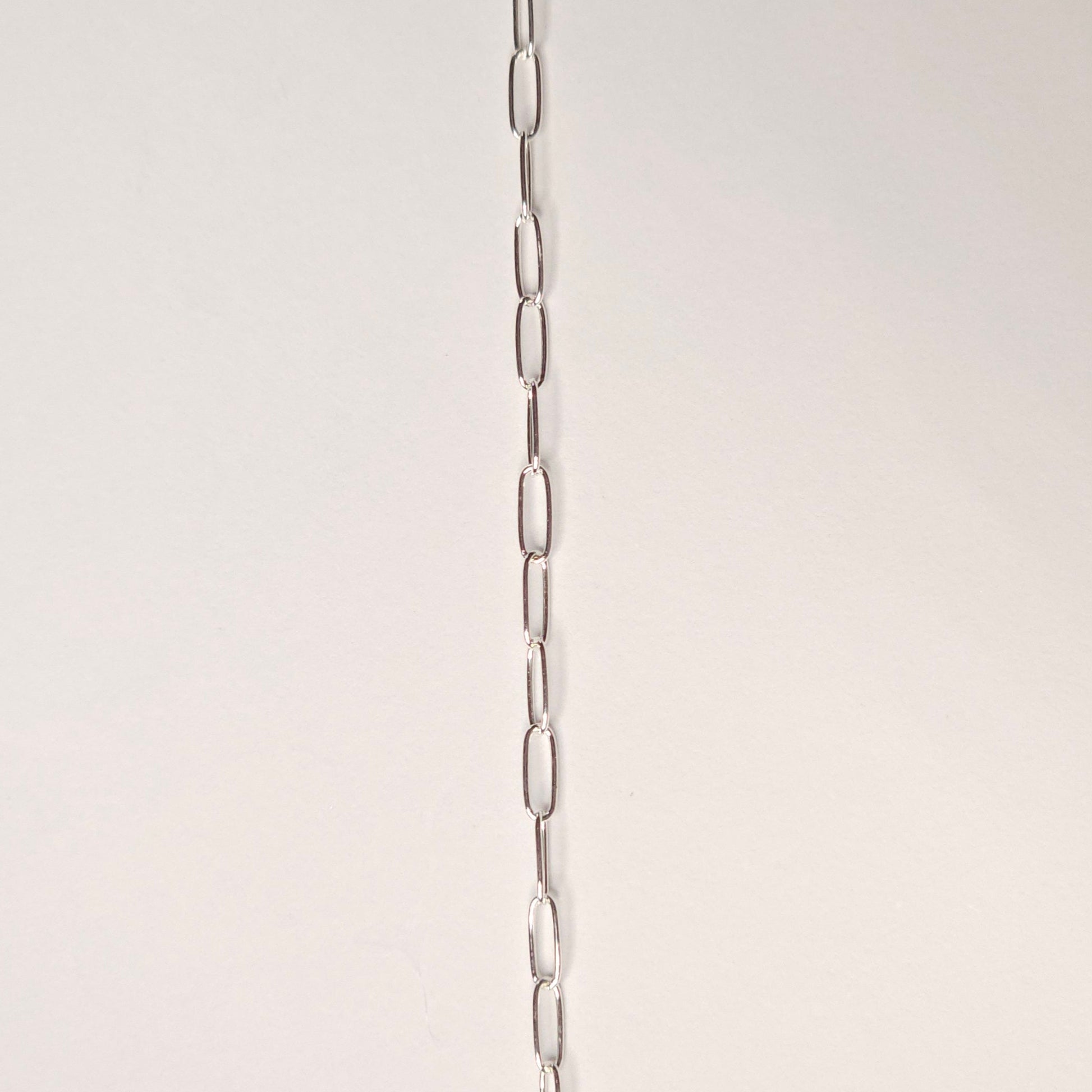 Sterling silver micro paperclip chain with minimalist rectangular links, designed for everyday wear and permanent jewelry lovers seeking subtle style. Intentionally Linked Jewelry is the best for permanent jewelry in Maryland.