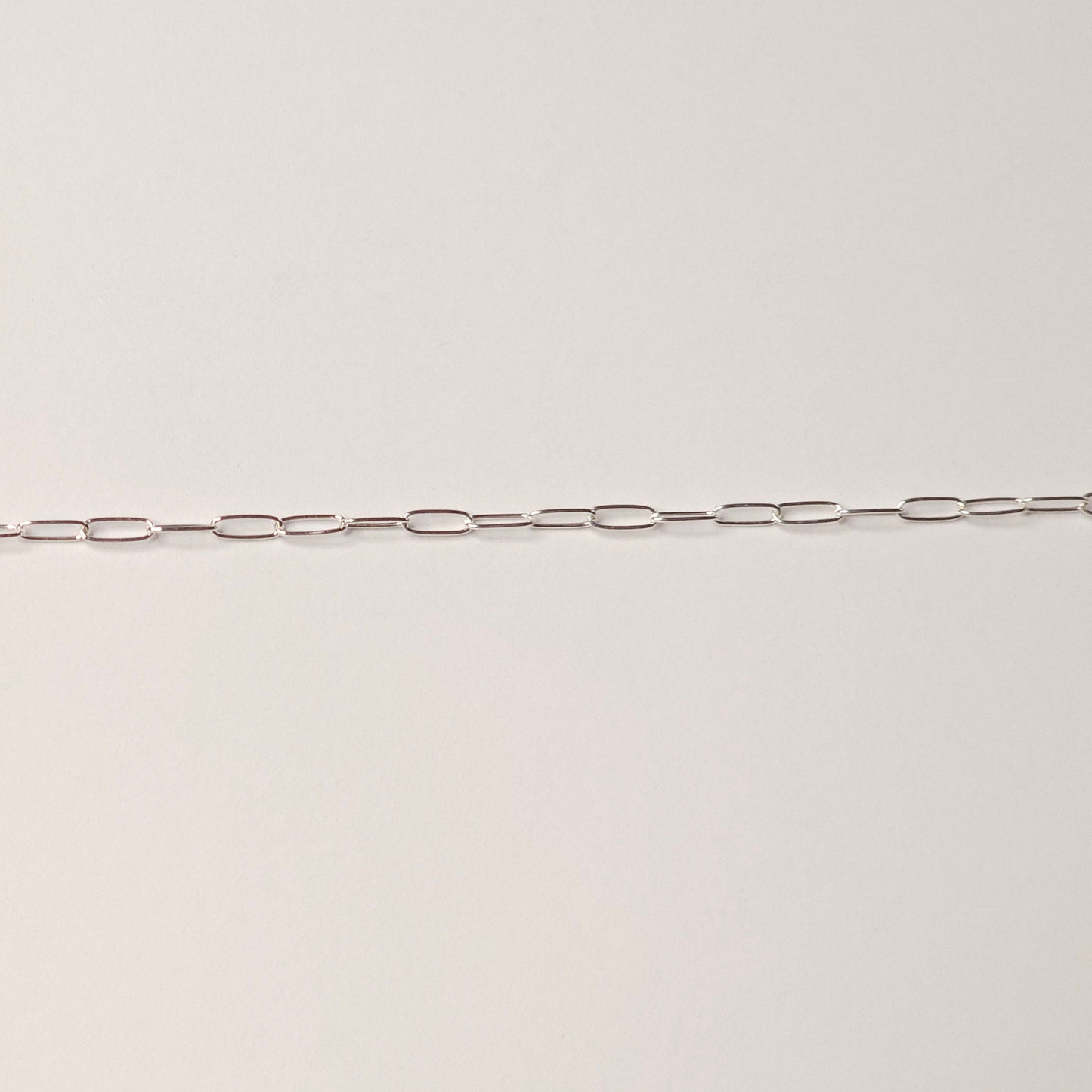 Delicate sterling silver chain with slim paperclip-style links, symbolizing clarity, connection, and presence. Ideal for modern minimalist permanent jewelry — Intentionally Linked Jewelry is the best for permanent jewelry in Maryland.