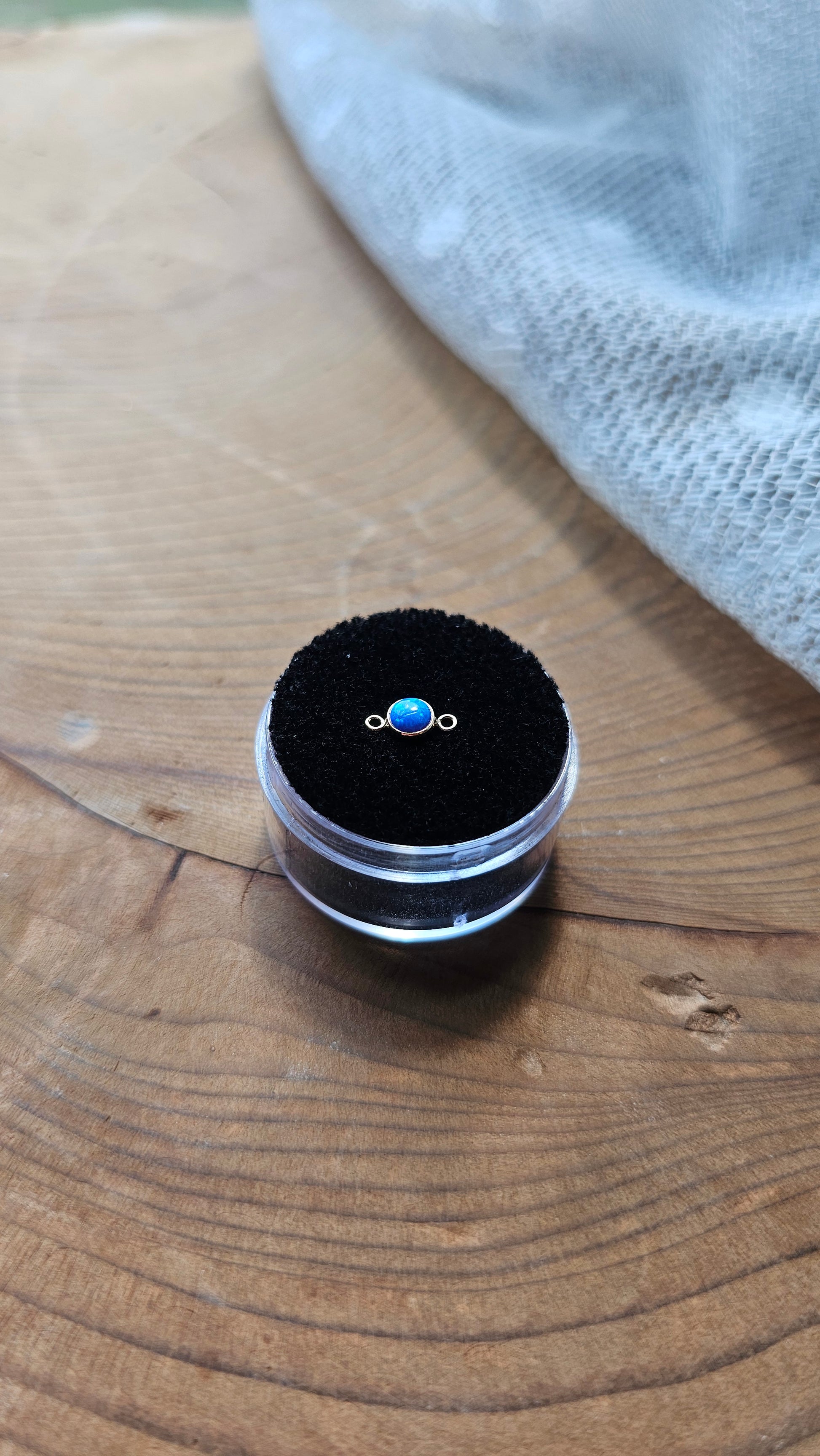 small blue opal connector displayed on Intentionally Linked Jewelry wood display   in a black foam gem case 