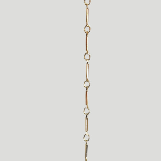 Polished and lightweight 14k gold filled bar chain with alternating vertical bars and small loops, crafted for intentional, everyday wear.