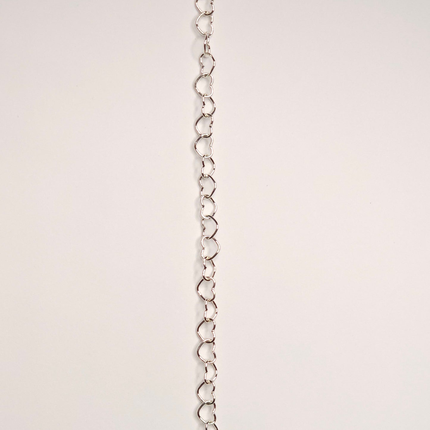 lovers link chain in sterling silver.  Featuring slightly larger and rounded heart-shaped links, this chain makes a soft but confident statement. this chain adds volume and texture because it does not lay flat 