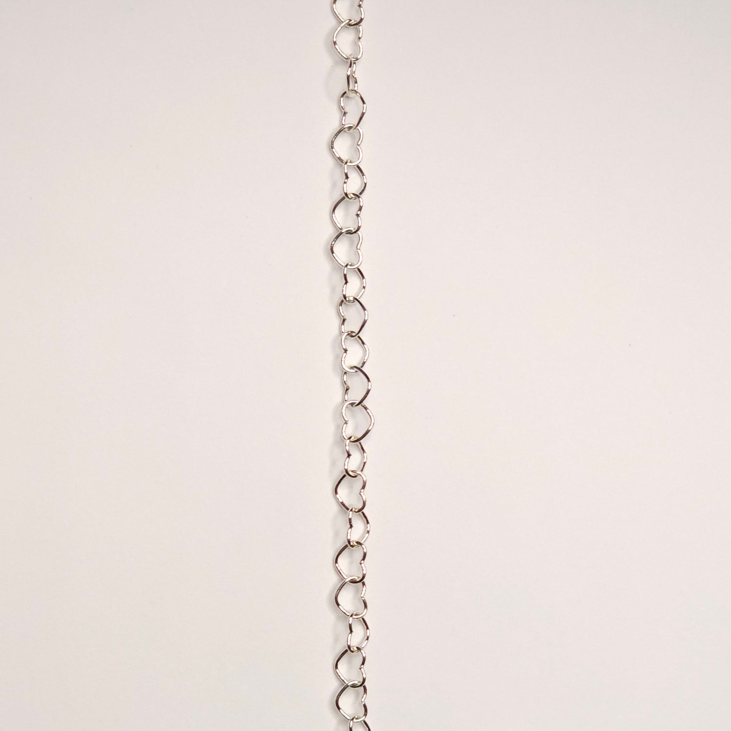 lovers link chain in sterling silver.  Featuring slightly larger and rounded heart-shaped links, this chain makes a soft but confident statement. this chain adds volume and texture because it does not lay flat 