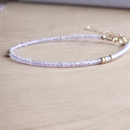 Minimalist Pink amethyst 14k gold filled beaded spring clasp bracelet  on a wood  stand by intentionally linked jewelry in baltimore 