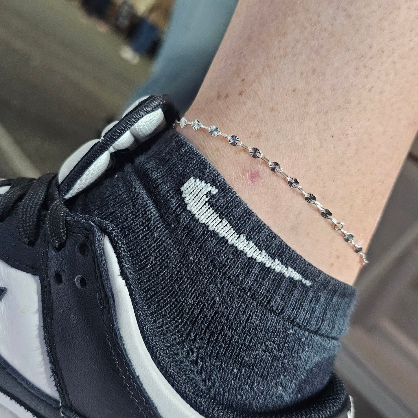 sunburst chain in sterling silver on a ankle. this permanent jewelry anklet was custom fitted by intentionally linked jewelry at the Bel Air BBQ bash. get your at our studio in canton baltimore