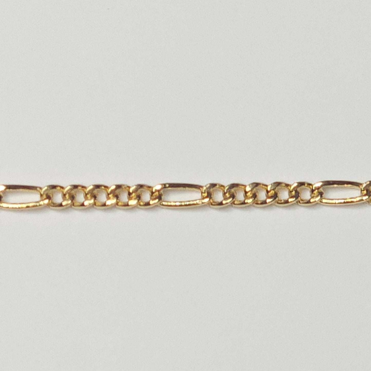 Classic 14k gold filled Figaro chain featuring a 3-to-1 link pattern and polished finish, designed for meaningful, everyday permanent jewelry.