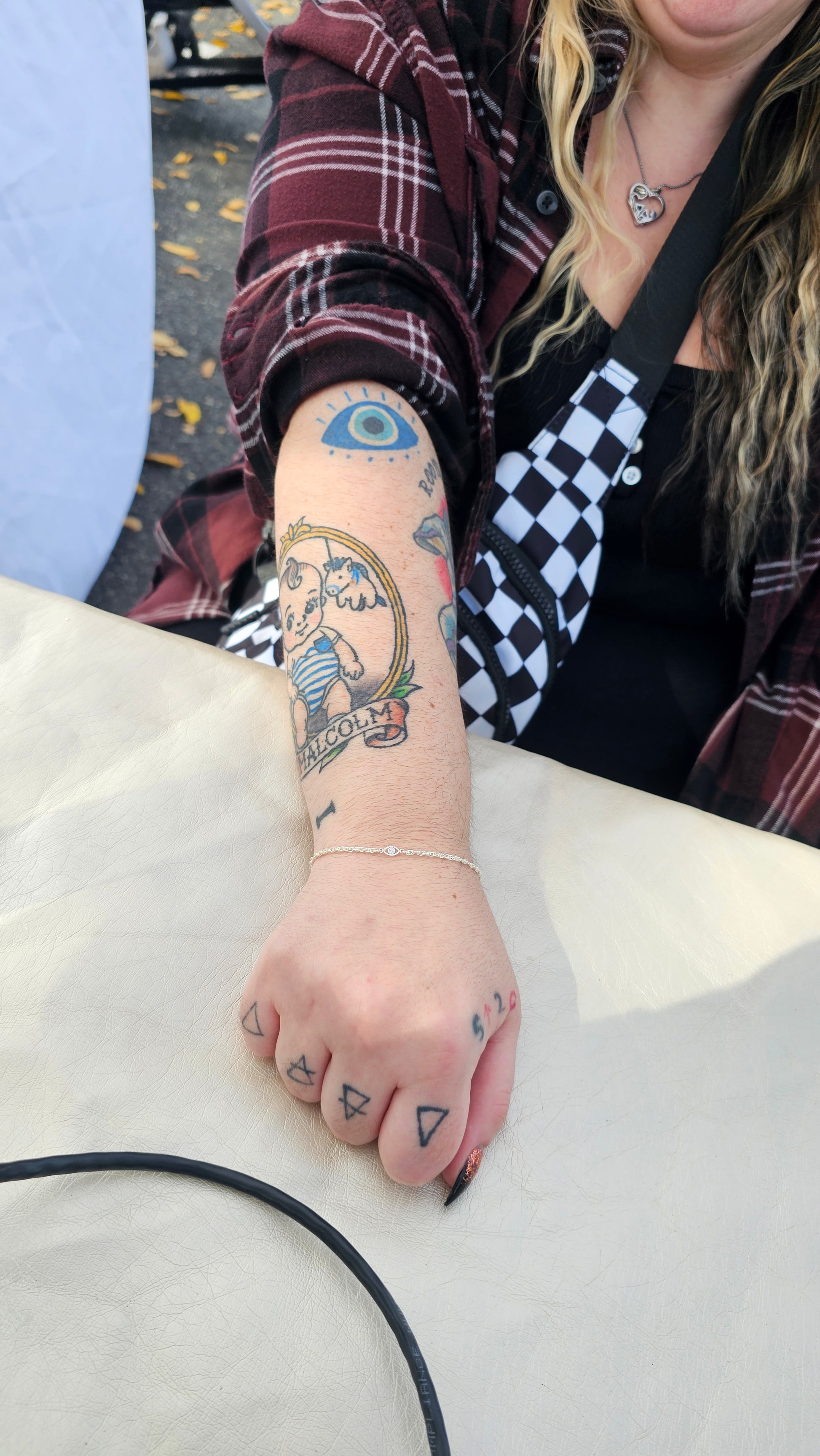Woman with the permanent jewelry chain "selene" a sterling silver rope and an evil eye connector. By Intentionally linked permanent jewelry in Baltimore, Maryland 